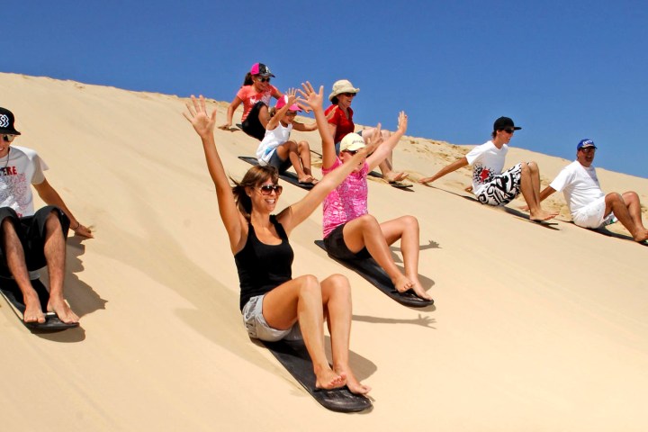 a group of people sitting at a beach